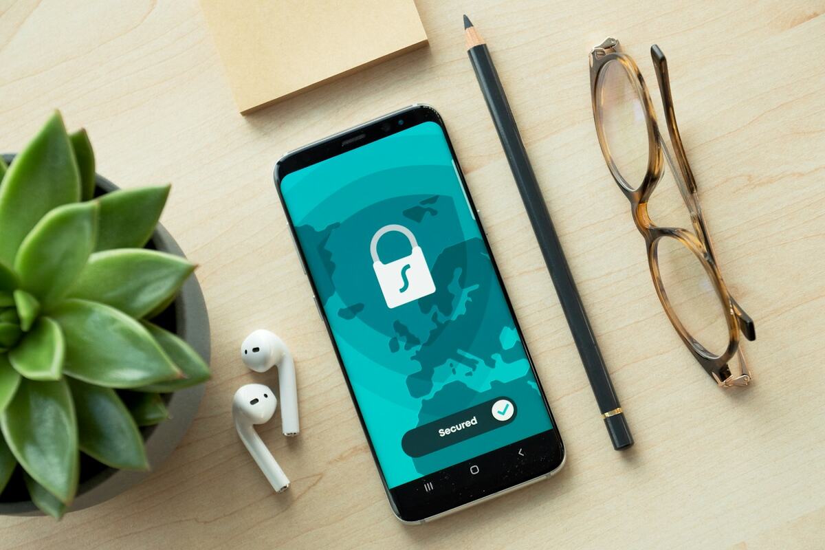Smartphone showing a security lock icon on a desk
